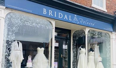 The front of a bridal shop with wedding dresses in the window.
